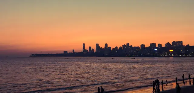 The Mumbai skyline across the sea at sunset