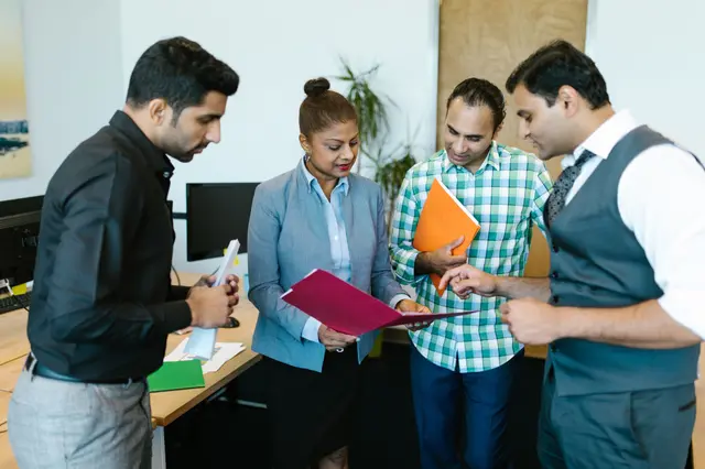 A team reviewing documents together in an office